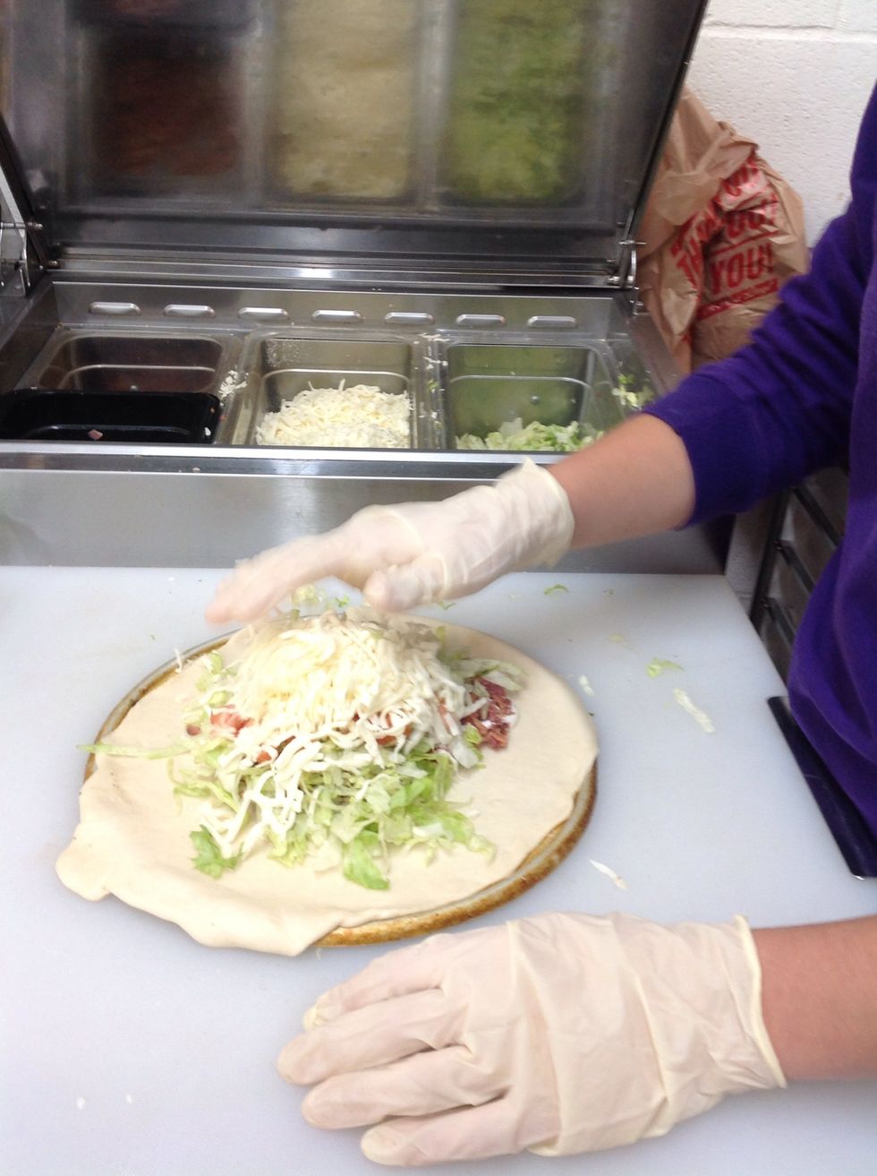 Topping my BLT calzone with mozzarella cheese