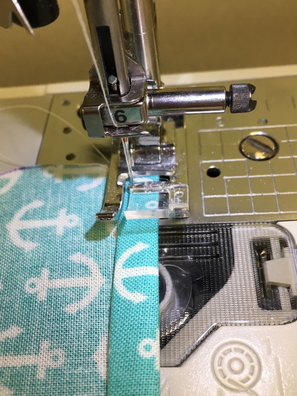 Topstitch, close to the bottom fold. This will secure the "flap" and hold the double turned hem in place.