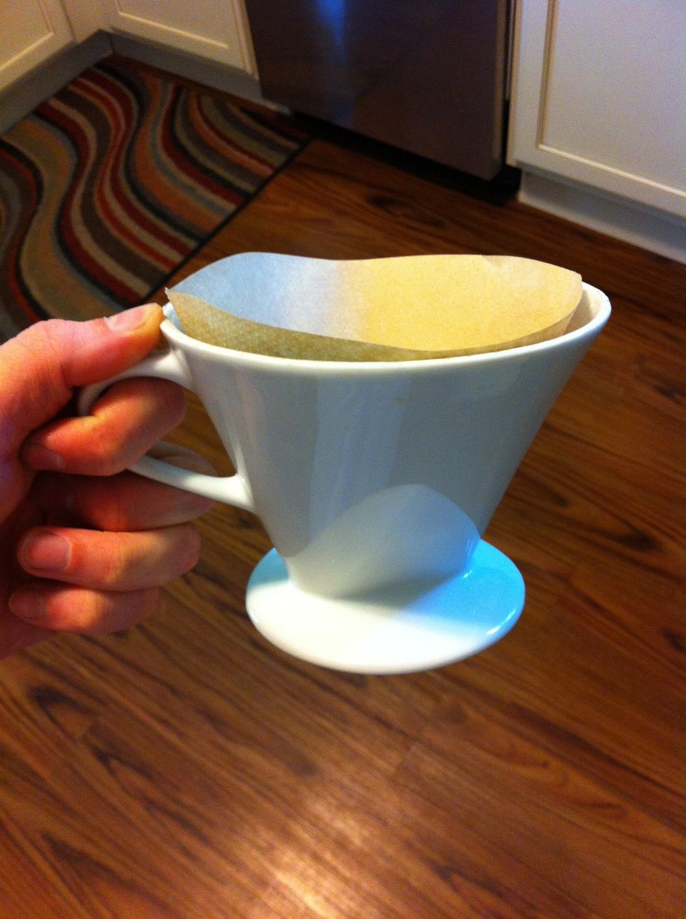 Toss a paper filter in your pour-over vessel. Many people prefer Mellita brand filters. You could also use a glass Chemex vessel and Chemex brand filters for even better quality.