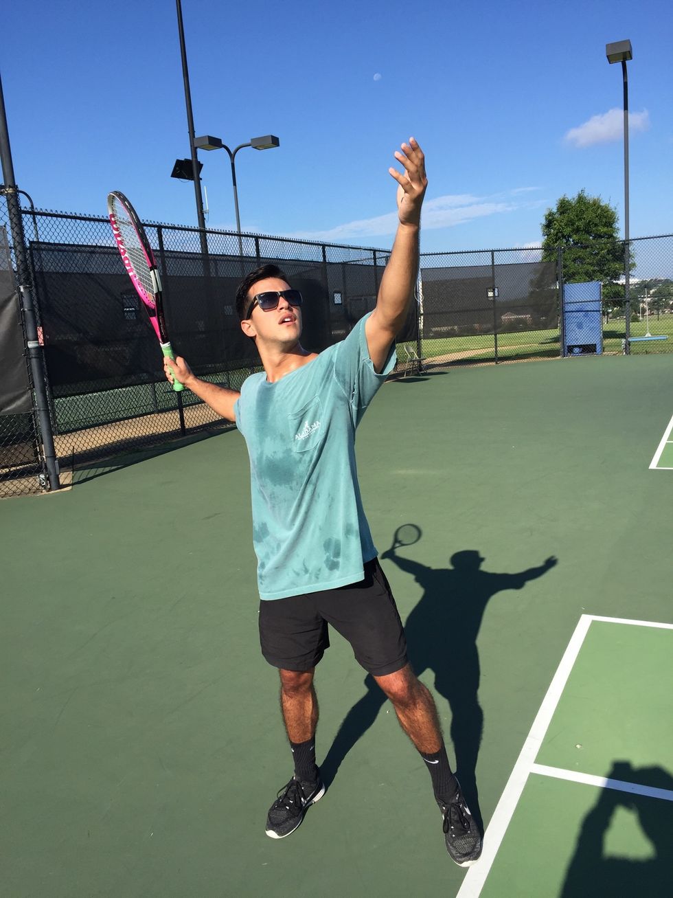 Toss and backswing: ball in non-dominant hand, locking left elbow. Toss ball without the fingers about 24 inches in front of the body. Sweep the racquet low, bringing it parallel to court.