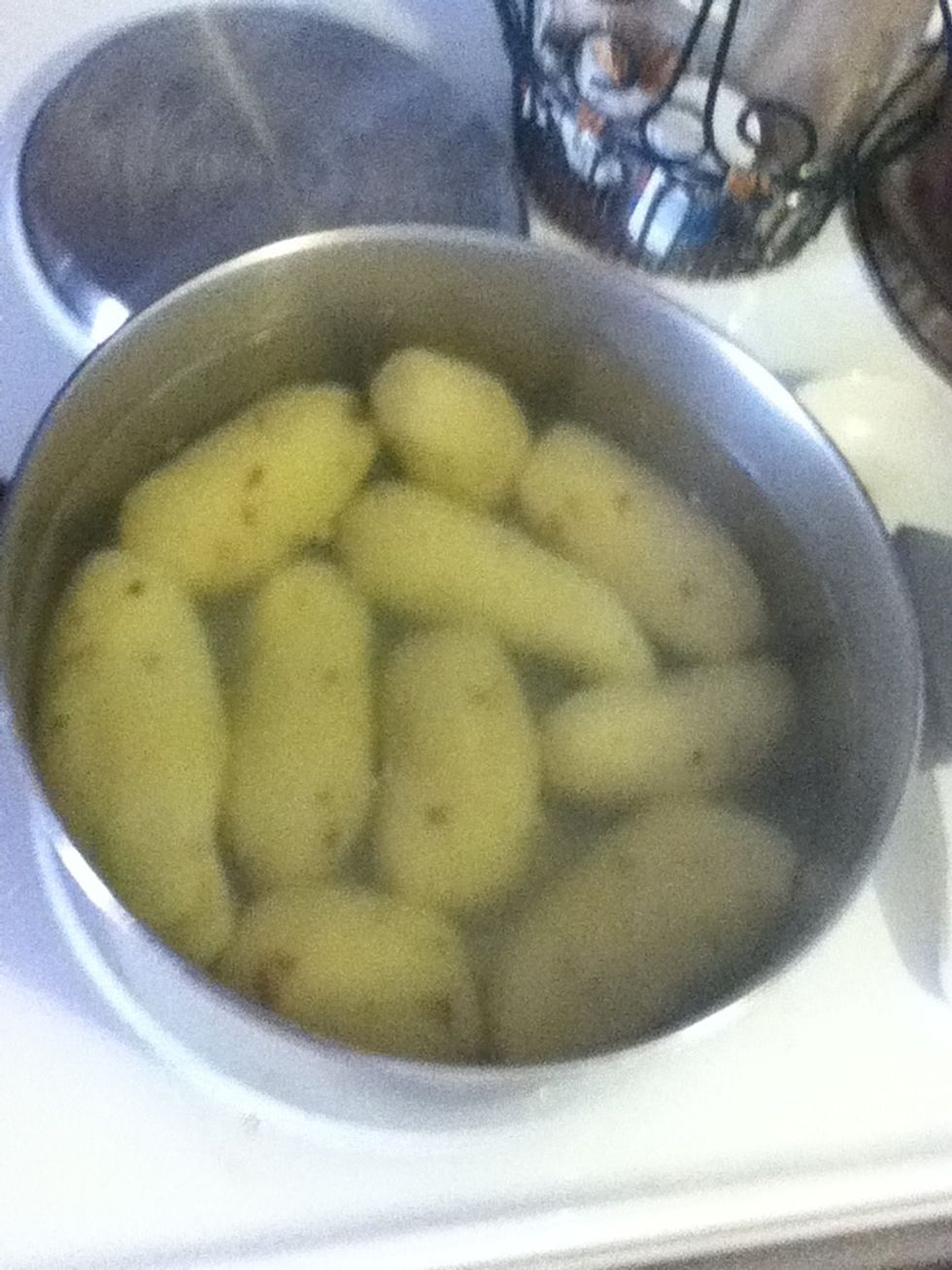 Toss 'em in and let 'em boil together. There's no time frame, you just gotta use the fork test to know when they're done. If it feels like a boiled potato when you poke it with a fork, then it's done.