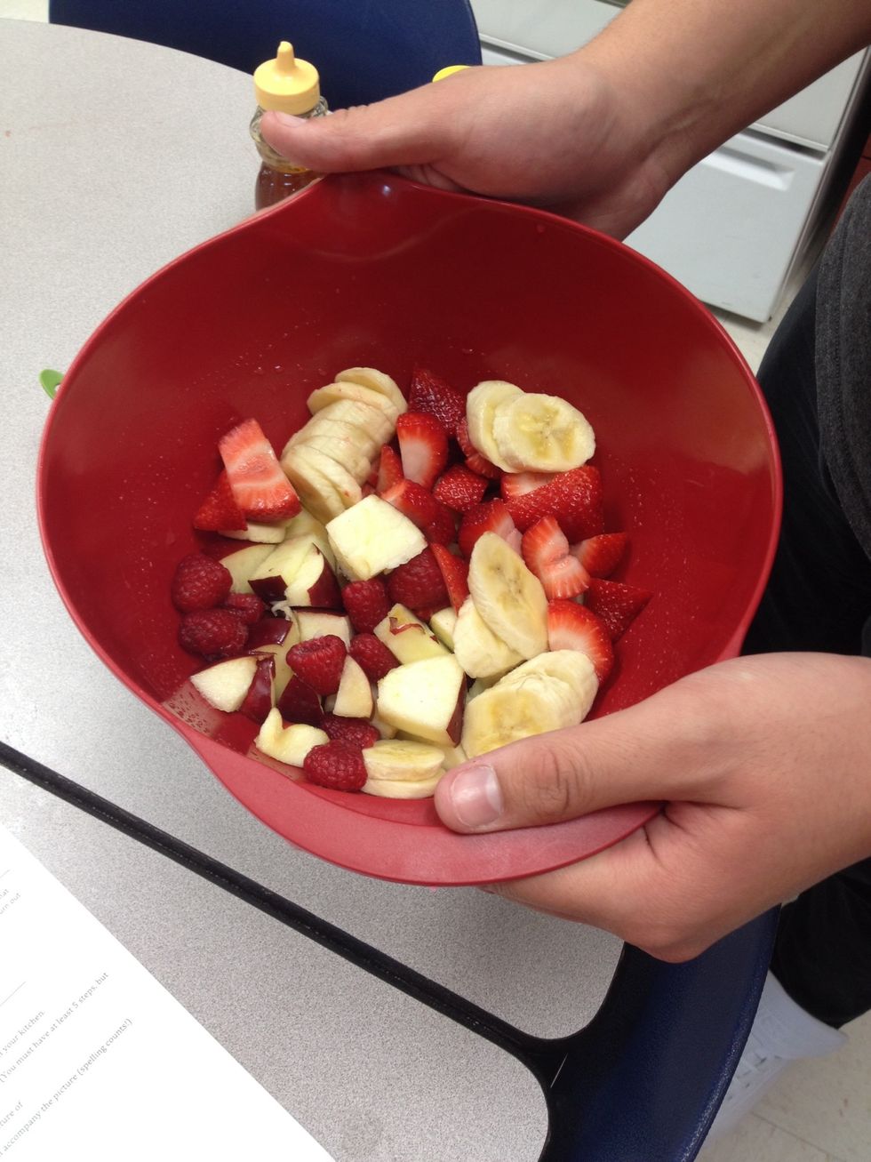 Toss fruit in bowl with honey-lemon mixture and enjoy finished product