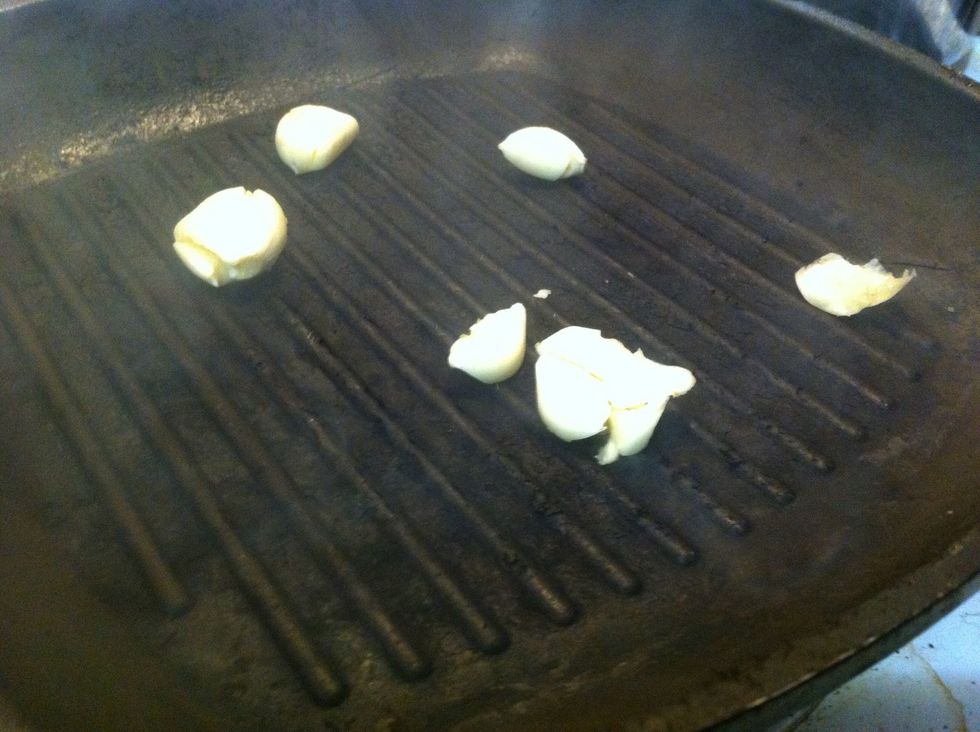 Toss garlic into preheated grill pan