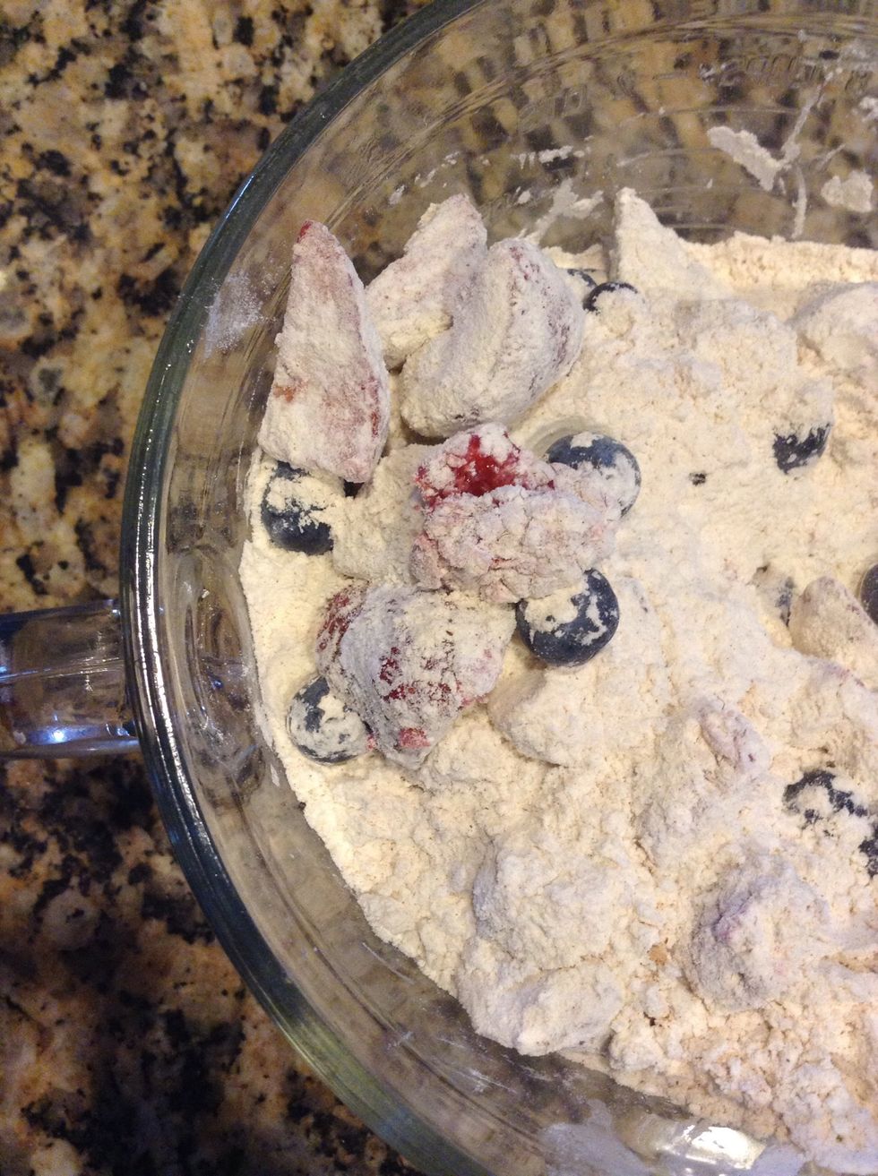 Toss gently and coat berries. This will help them not sink to bottom of muffin while baking