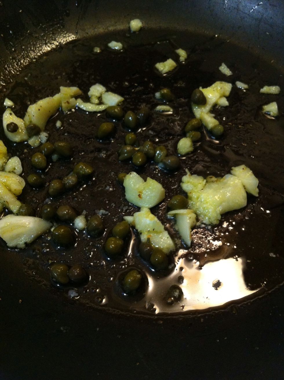 Toss in a spoon full of capers and toast them with garlic