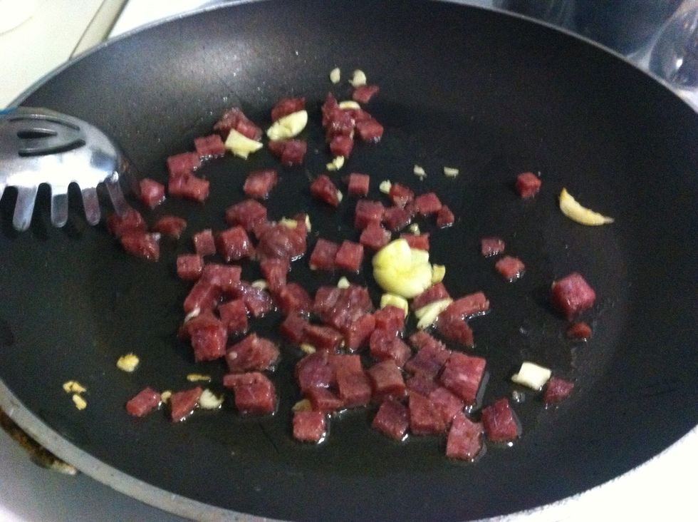 Toss in salami to brown slightly (you don't want to cook it - I might do this after cooking down the red pepper a bit)