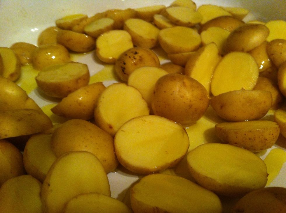 Toss in salt, rosemary and olive oil in oven tray