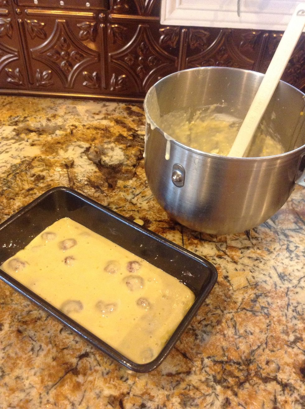 Toss in them berries, but don't over mix. Pour into generously greased loaf pan.