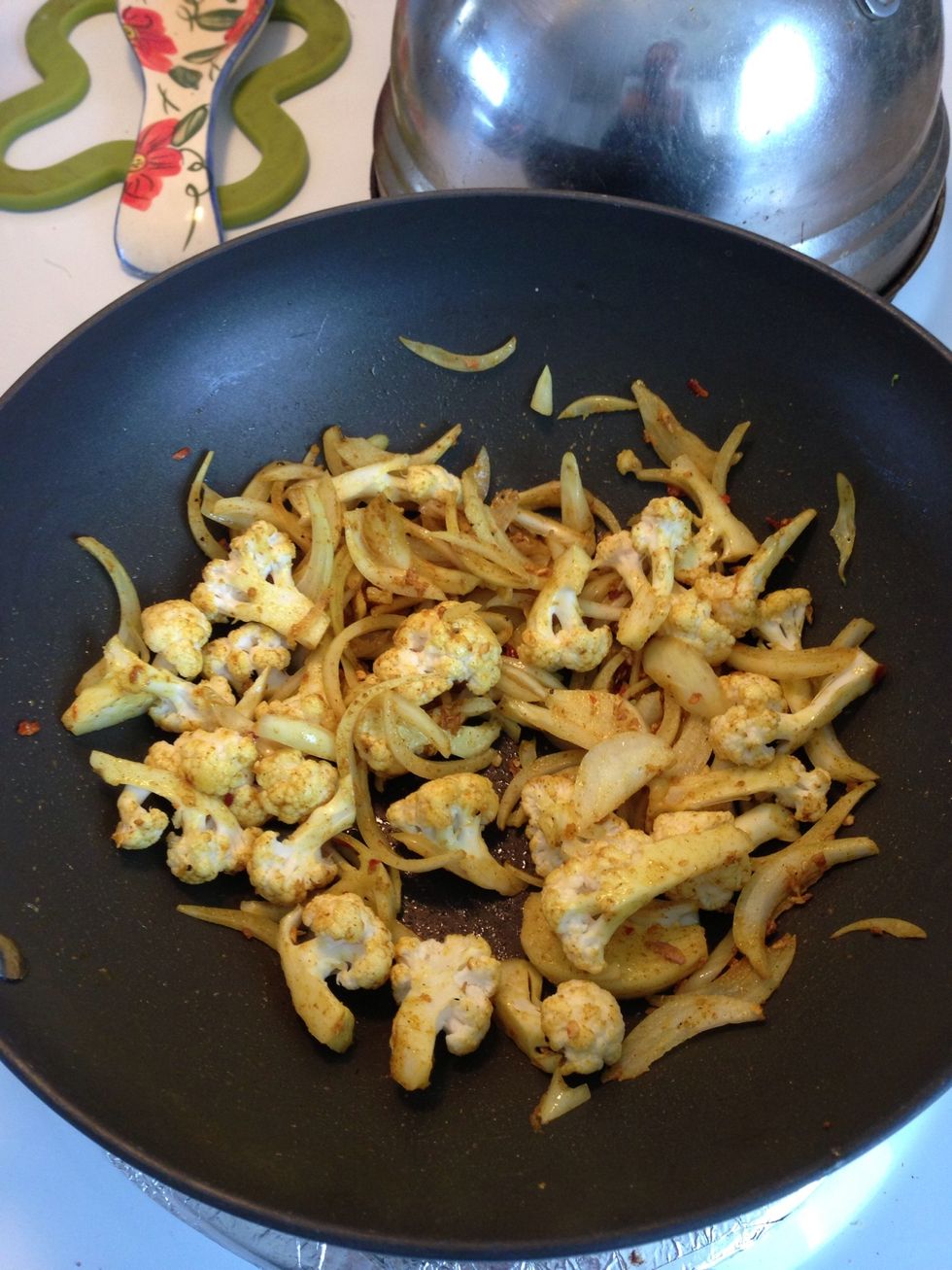 Toss in veggies and cook until cauliflower begins to soften.