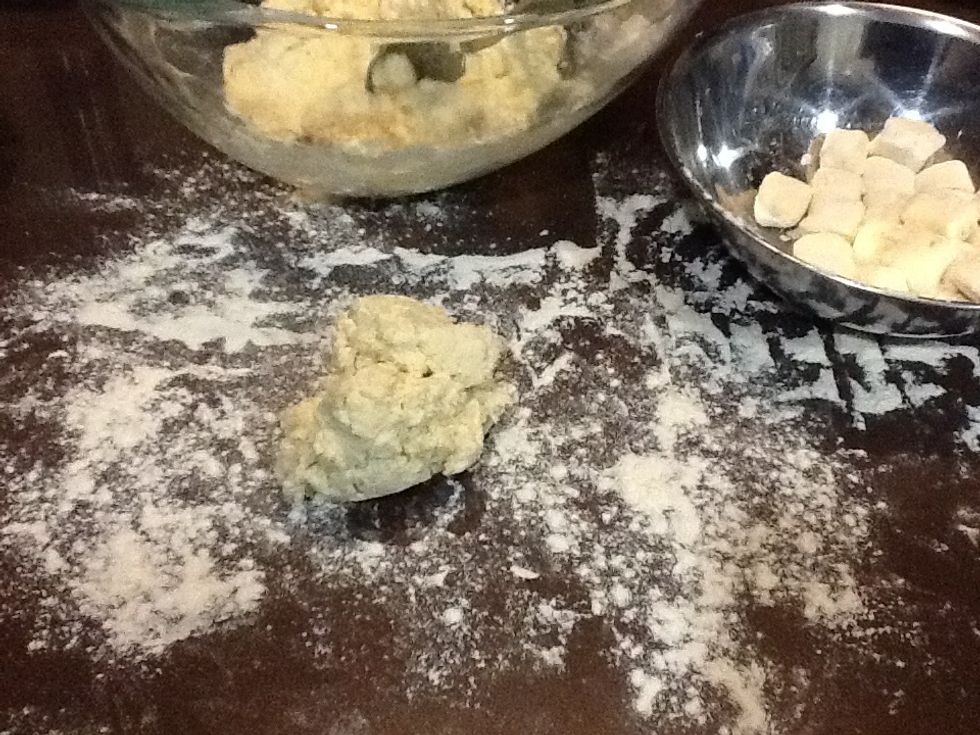 Toss pillows in a little extra flour and place in a container so that they are not touching each other.  Repeat rolling dough in batches until all the dough has been rolled and cut into pillows.