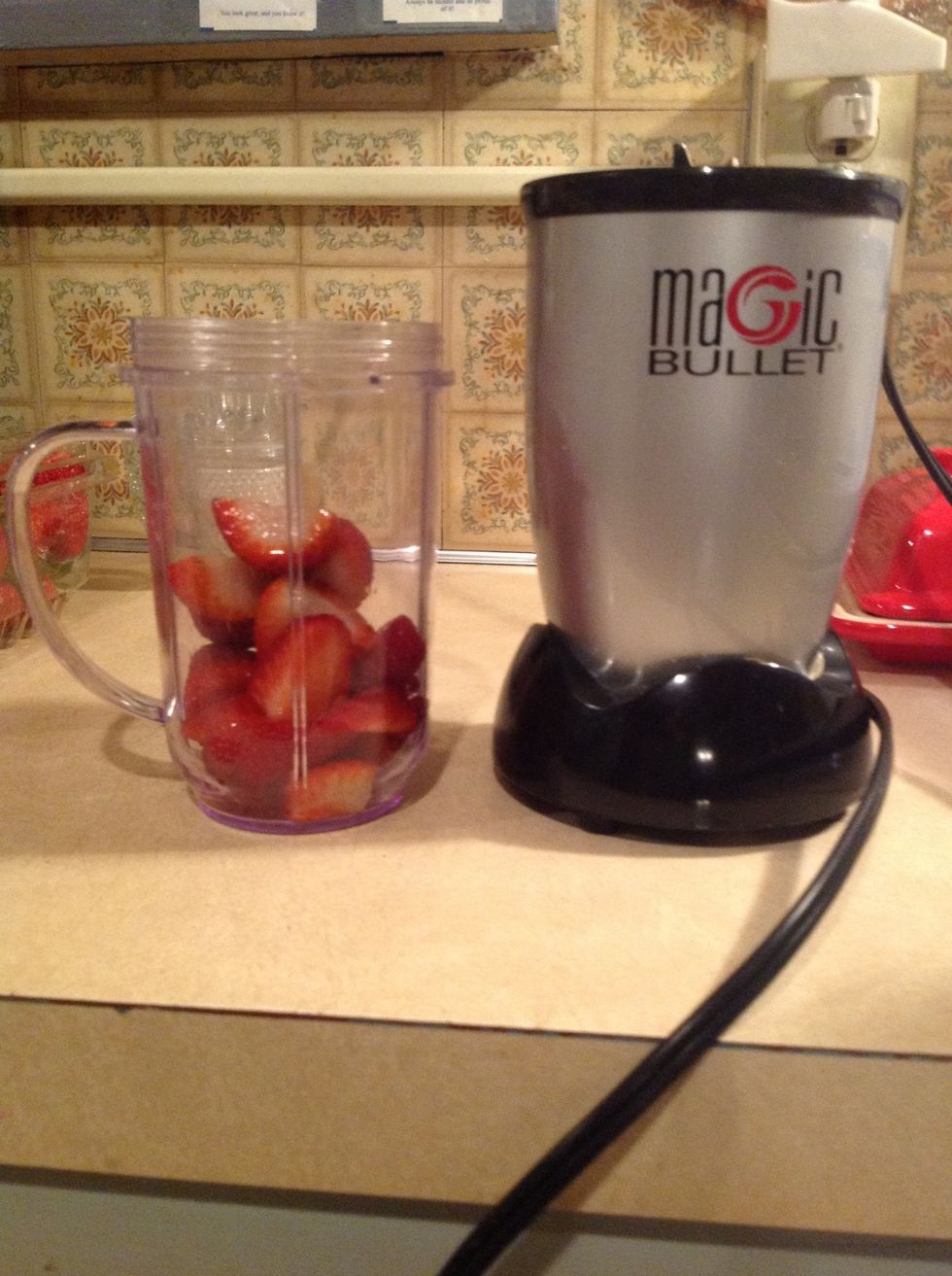 Toss strawberries into your blender.