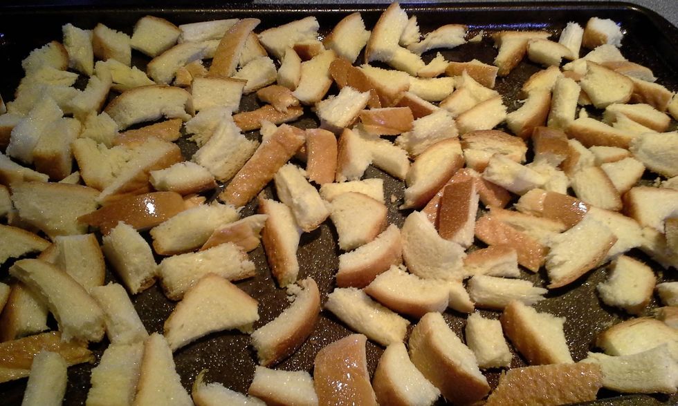 Toss the bread in olive oil and garlic powder.  Bake in oven at 350 degrees for 10 minutes.  You now have homemade croutons for your salads for the week.