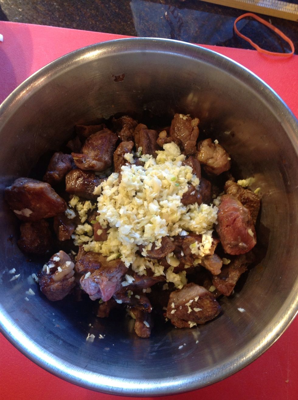 Toss the browned lamb with the minced garlic let the mixture rest while saut\u00e9 ing celery and shallot on medium heat.