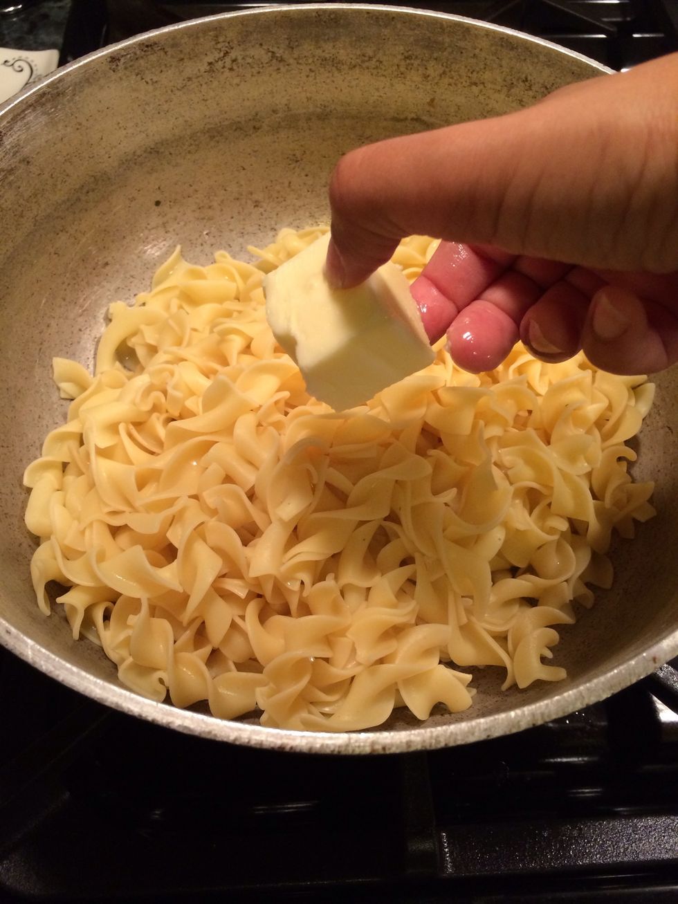 Toss the butter into the noodles
