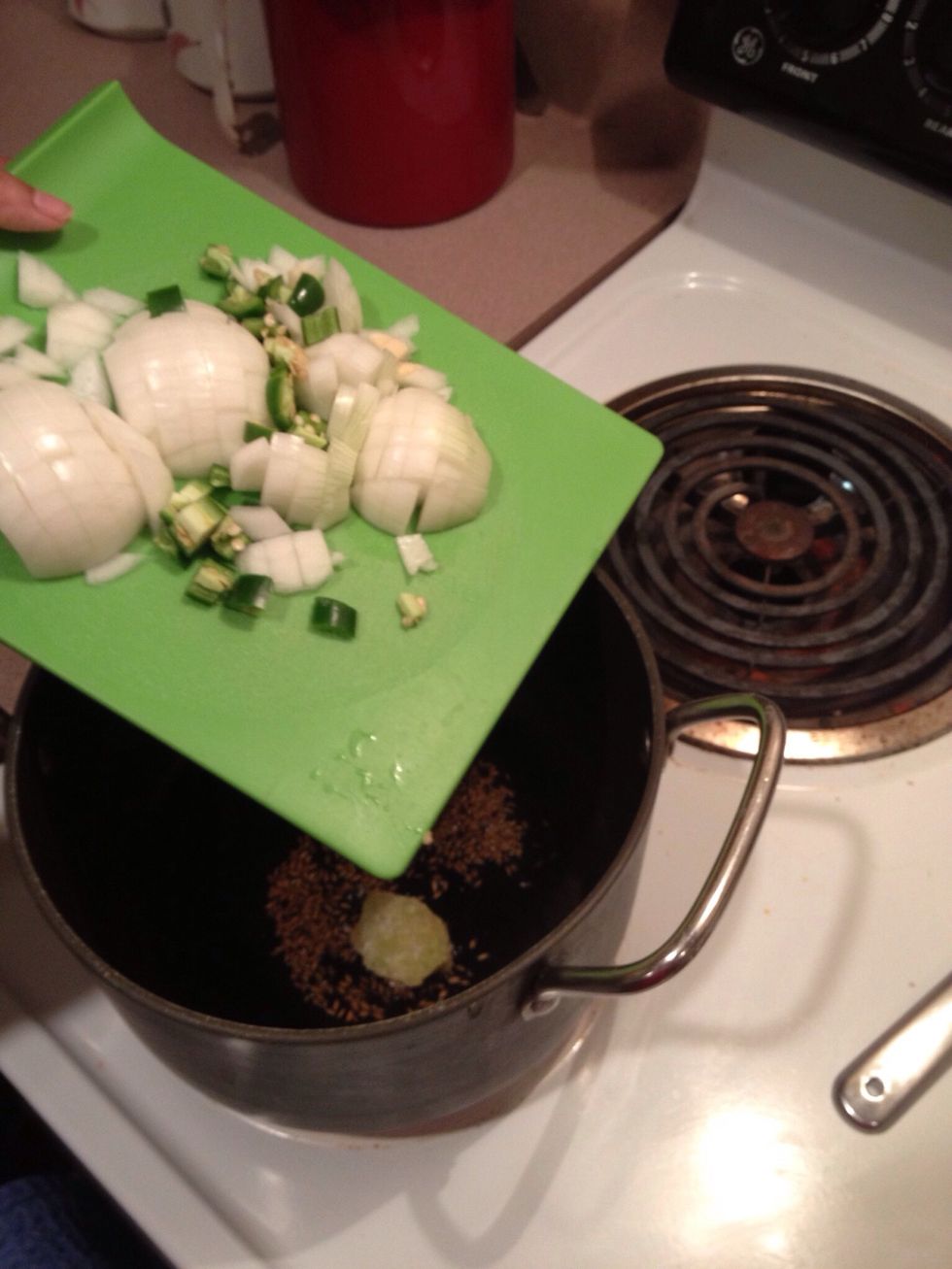 Toss the chopped onions and green pepper into the pot.