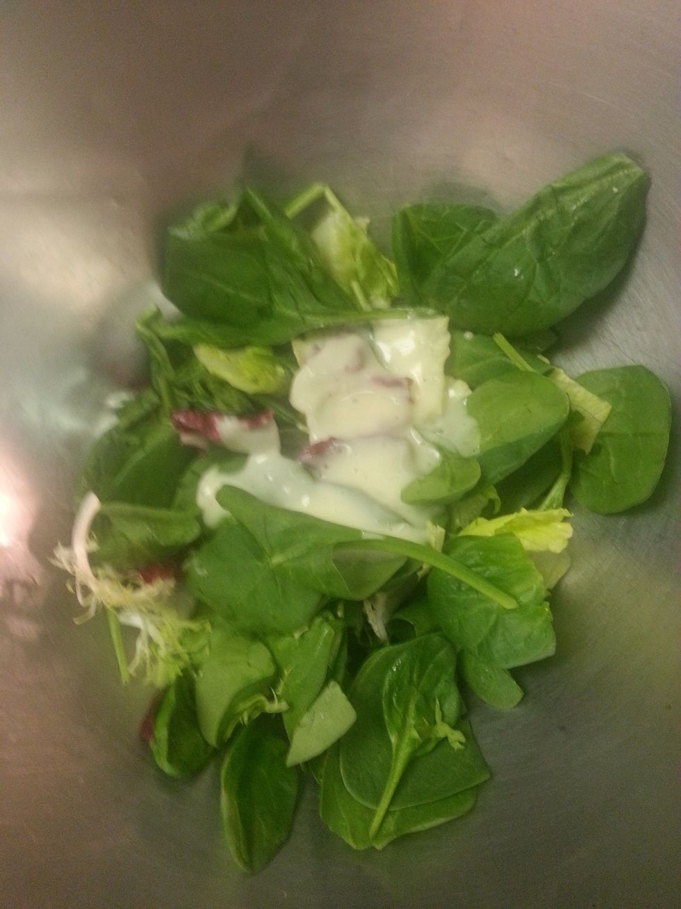 Toss the greens with vinaigrette