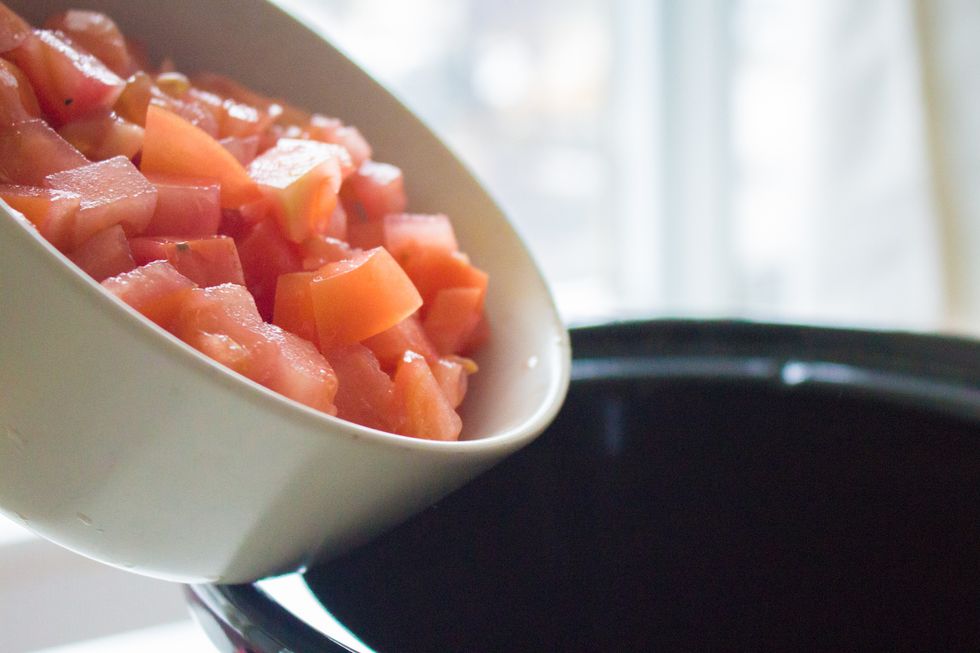 Toss the tomatoes into the crockpot.
