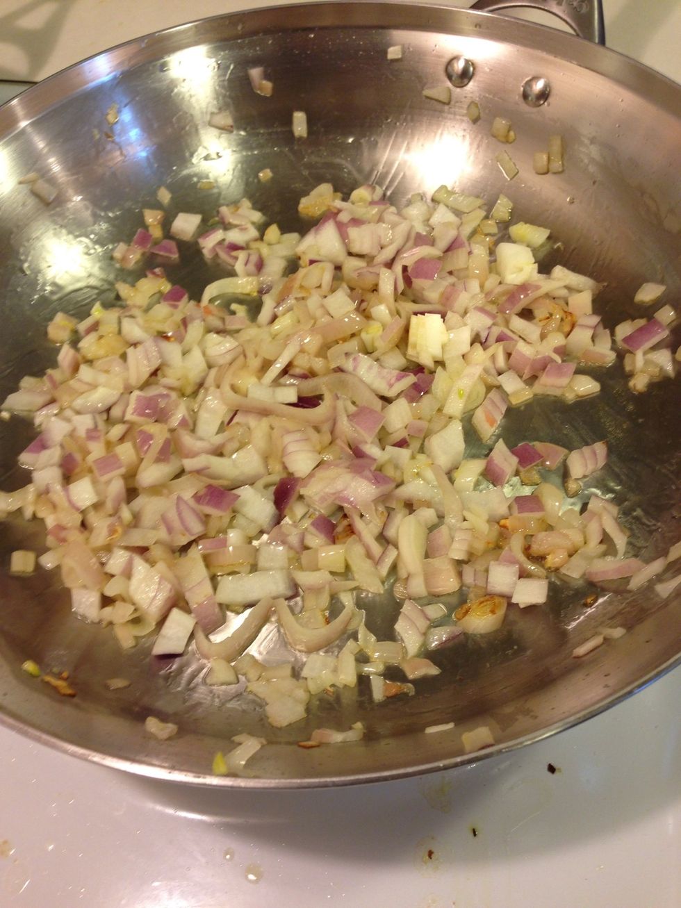 Toss those onions in!!! Sweat those for about 5 minutes, stirring.