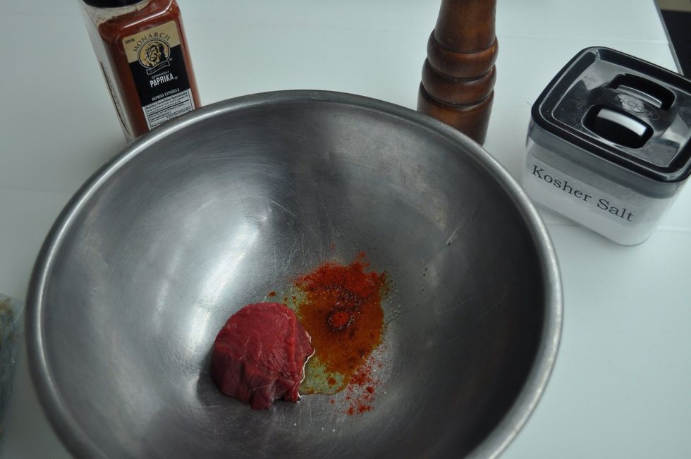 Toss your steaks in a bowl with olive oil, salt, pepper, and paprika.