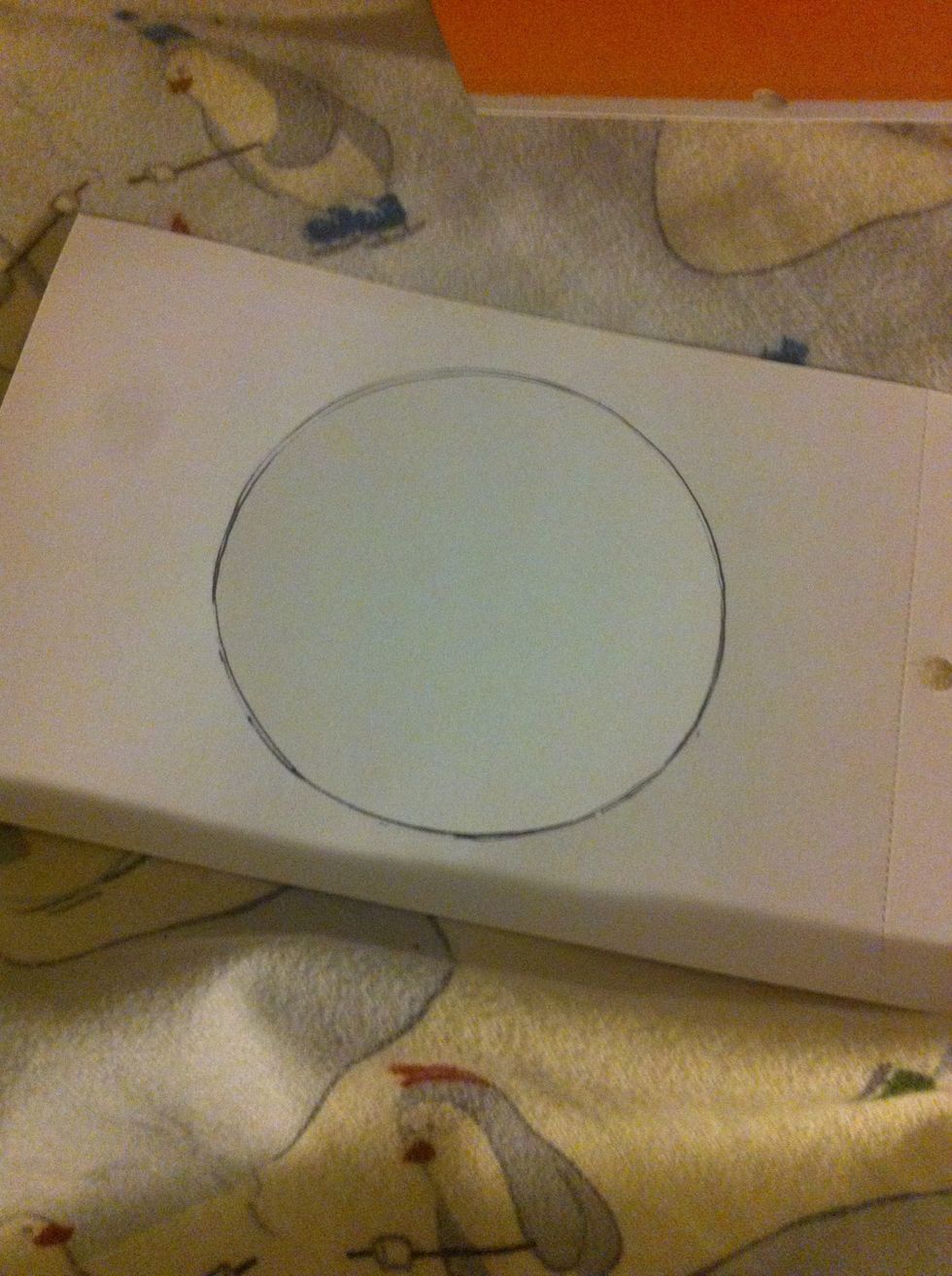 Trace a circle on the yellow paper.