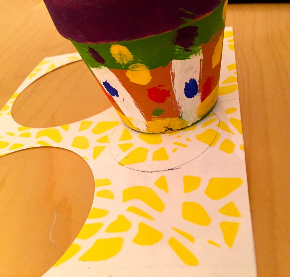 Trace a small round object to make a small circle. Smaller than your "petal" circles.