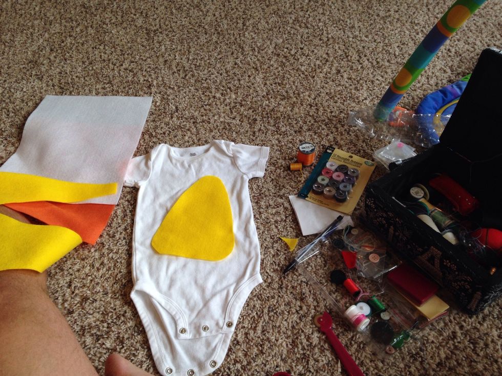 Trace and cut the yellow felt in the shape of a candy corn