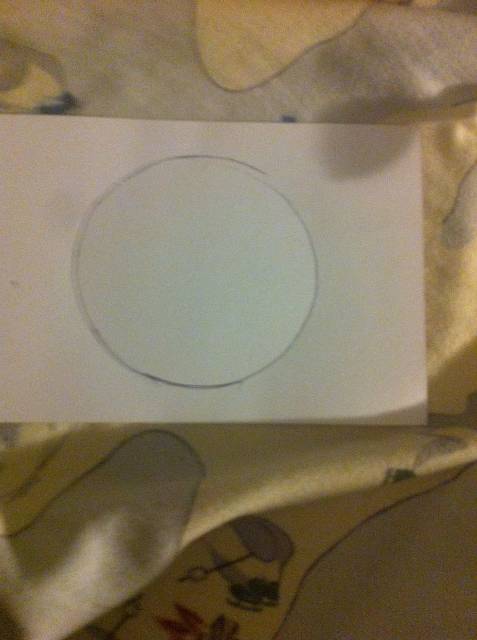 Trace another circle on the orange paper.