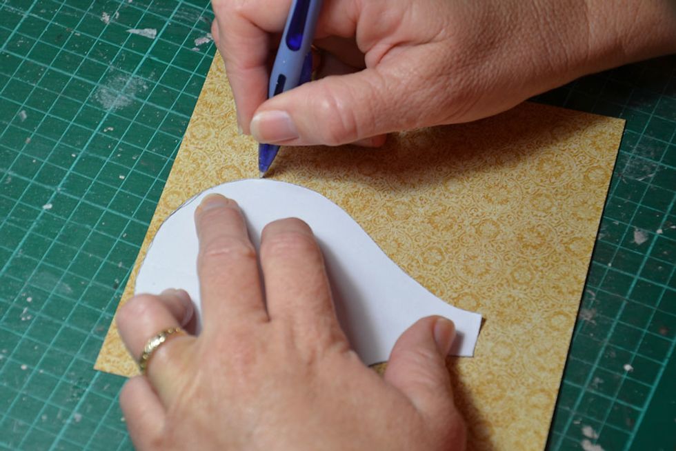 Trace around the balloon shape. You will need about 20 of the balloon shapes.