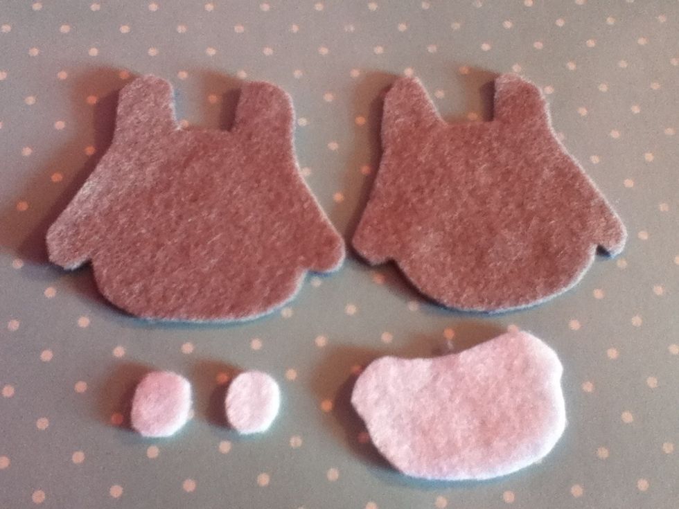 Trace around the large template onto grey felt twice and cut out. Draw around the smaller one on white felt and also cut out two circle pieces for the eyes