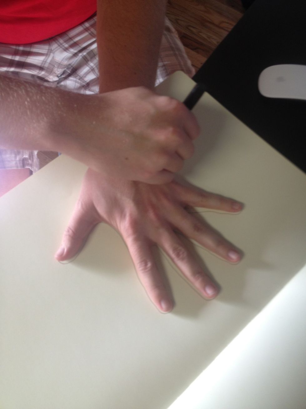 Trace hand onto paper.