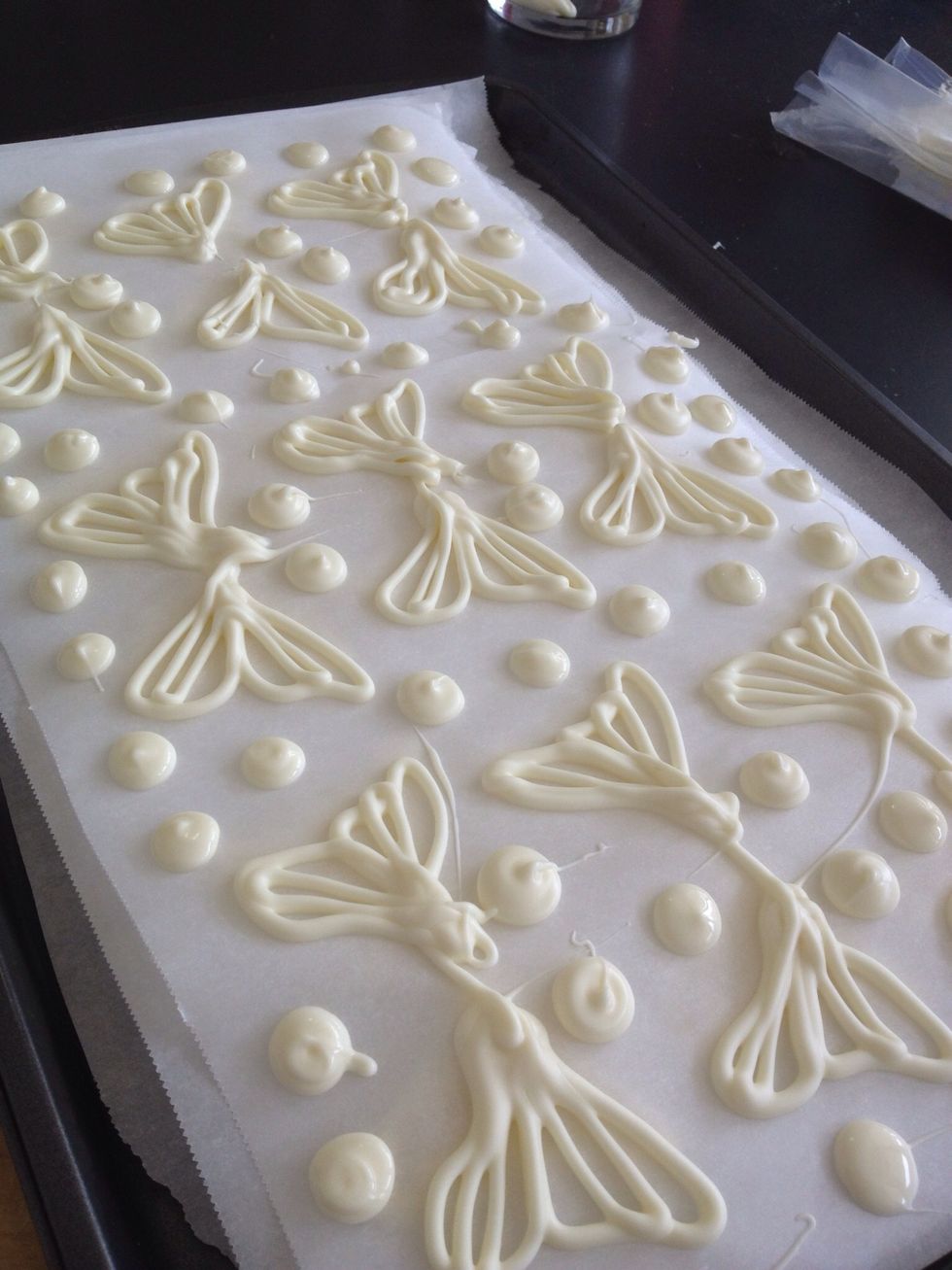 Trace over the outlines. Be sure to add a base- a stem to allow the wing to stick into the icing of the cake or cupcake.  Feel free to try other colors, fill the wings in or try other shapes!