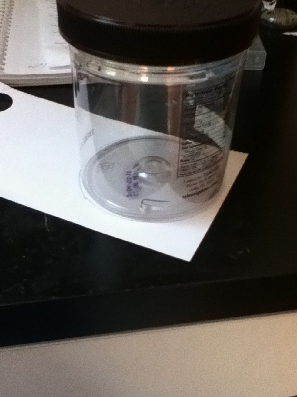 Trace the base of your cylinder onto your paper. It really doesn't matter how big it is.