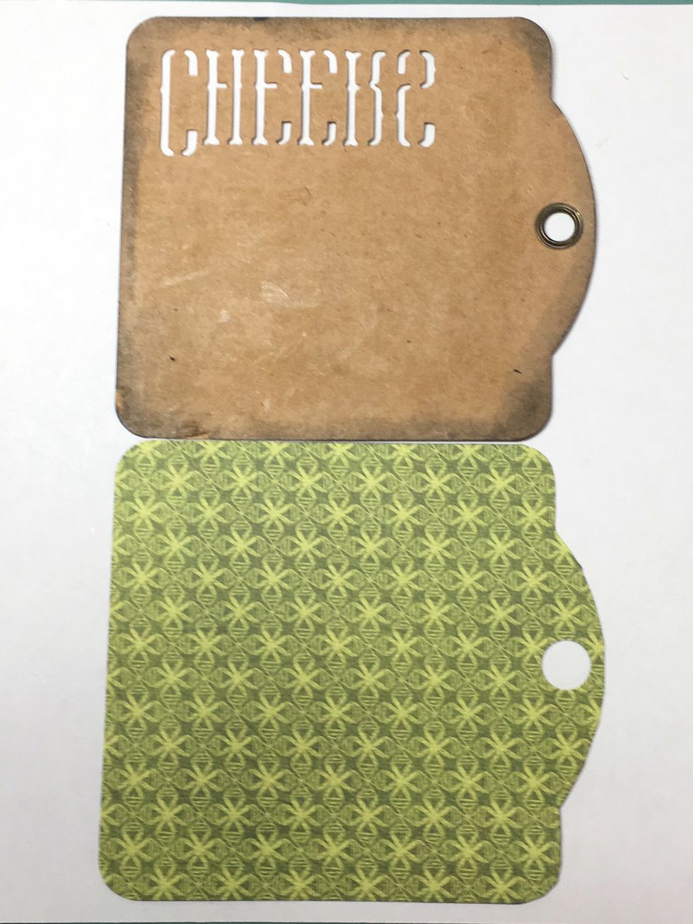 Trace the Cheers tag onto a piece of design paper. Cut out the traced tag and use a 1/2" hole punch to punch the hole.