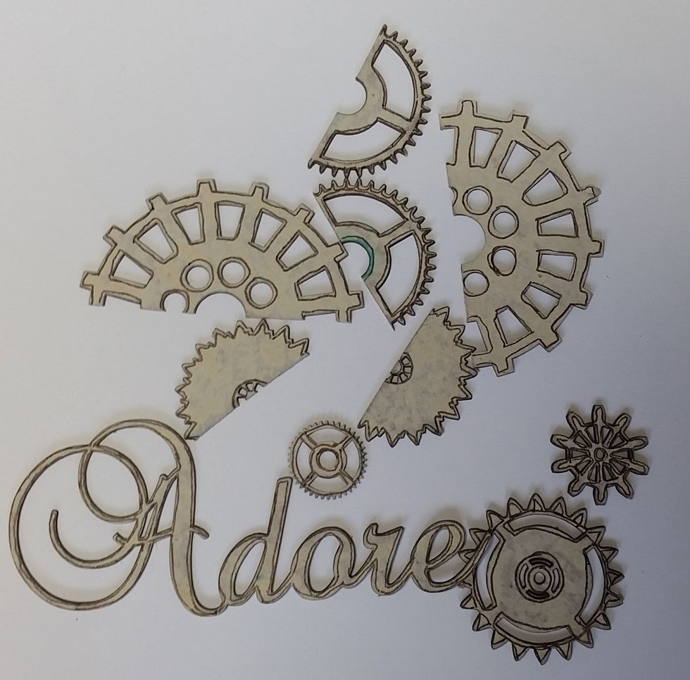 Trace the edges of the chipboard pieces with the Chocolate Tombow Dual Brush Pen fine tip end.  In the end I changed my mind with the word "Adore" and painted it plain again.