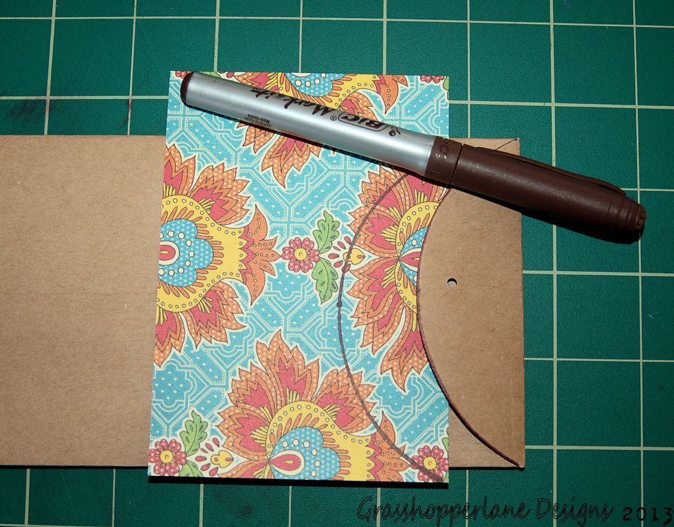 Trace the flap of the envelope twice onto decorative paper, trim & adhere. Using a mini hole punch - punch a hole in the center of the flap.