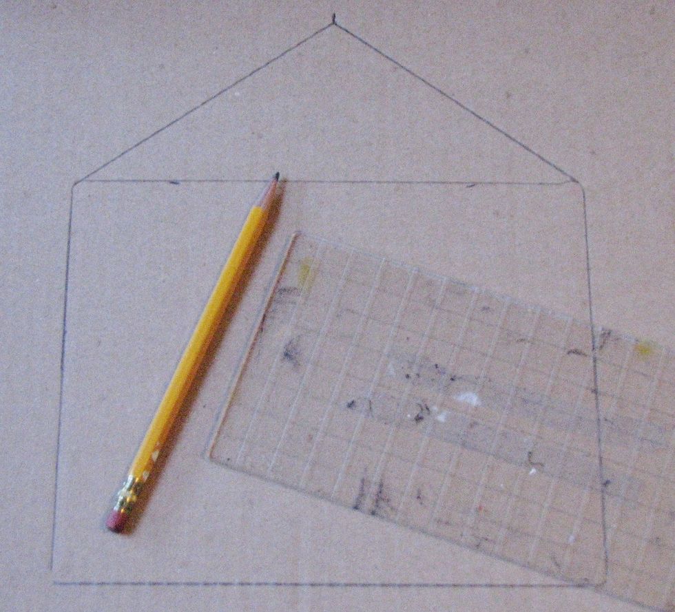 Trace the general shape of your house on the chipboard. The base of this house measures 8" across x 6.5" tall not including the peak. The peak adds an additional 3".
