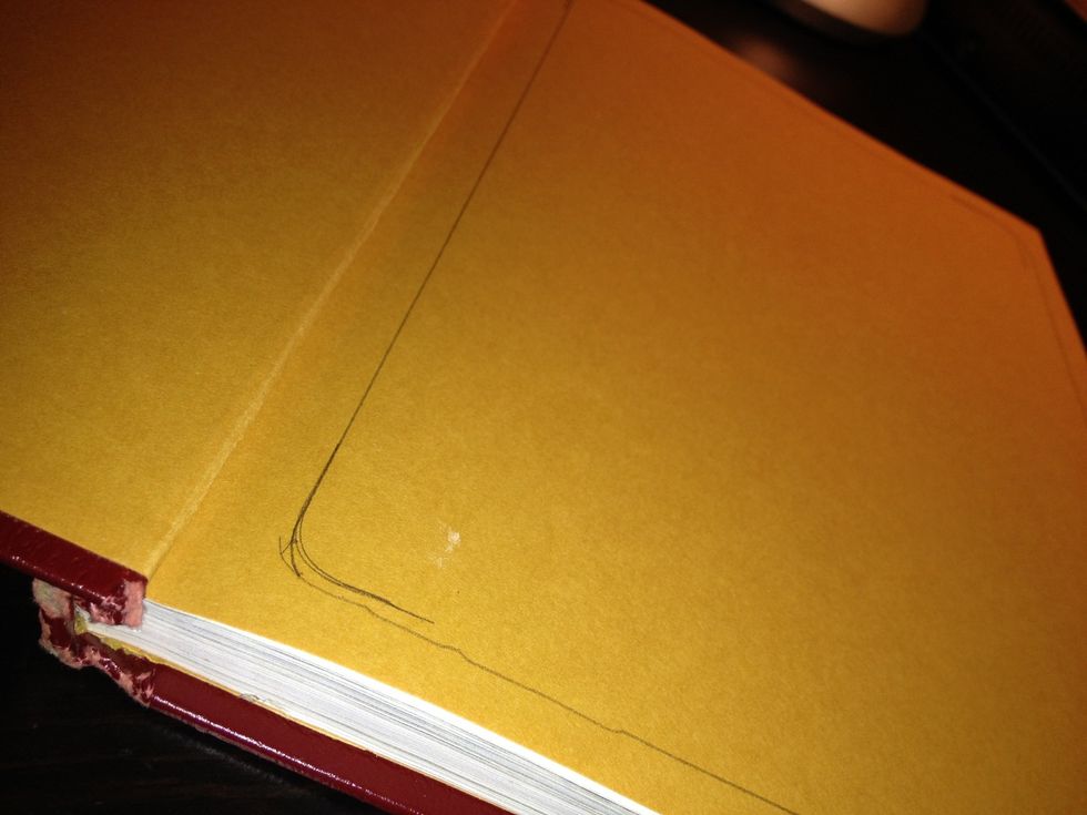 Trace the tablet's shape inside the book. Youll be cutting along this lines and removing the pages.
