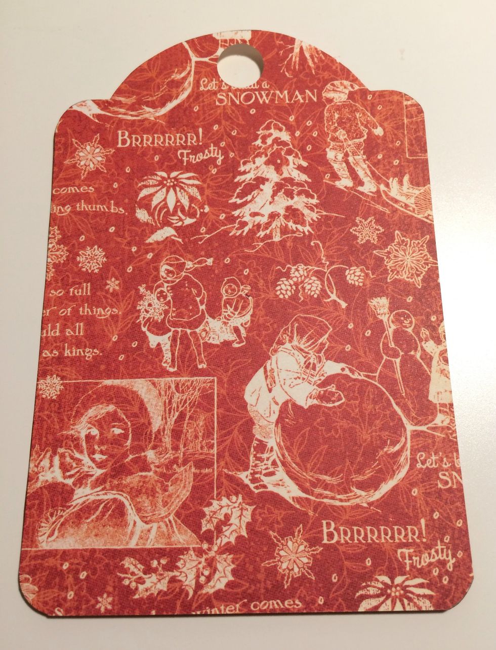 Trace the tag around February Calendar page. Once the tag is traced, cut the tag out. To finish the tag, use a 1/2" circle punch and punch a hole at the top of the tag. Round all four corners.