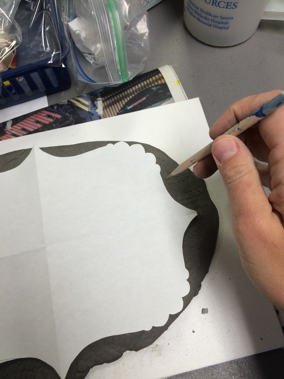 Trace the template on the textured clay slab.