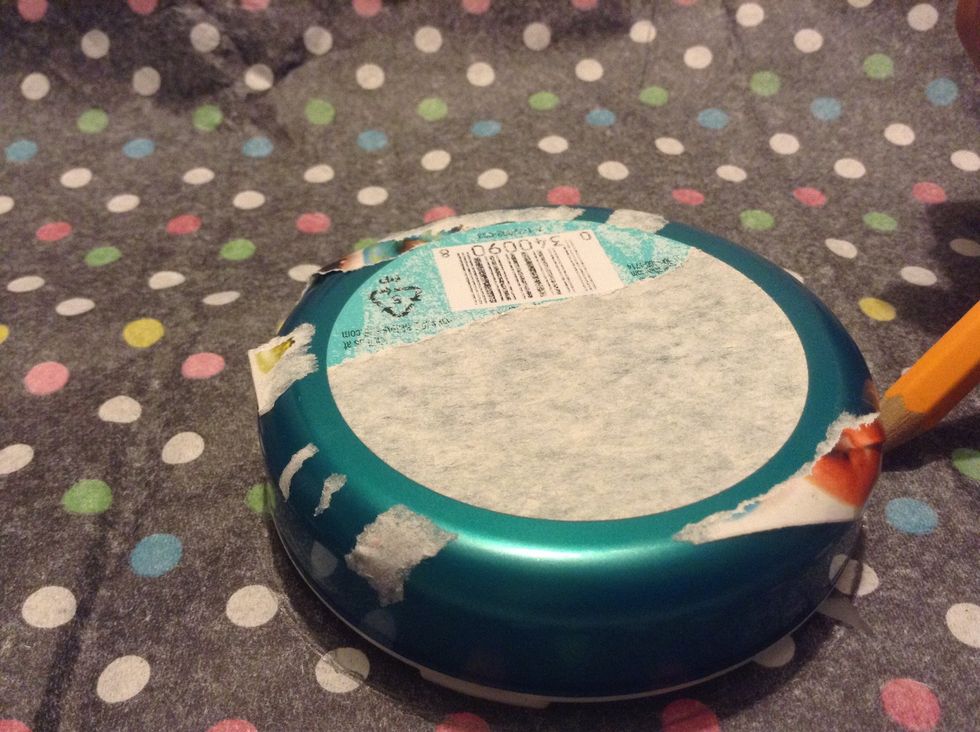 Trace the top of the box on the tissue paper using a pencil