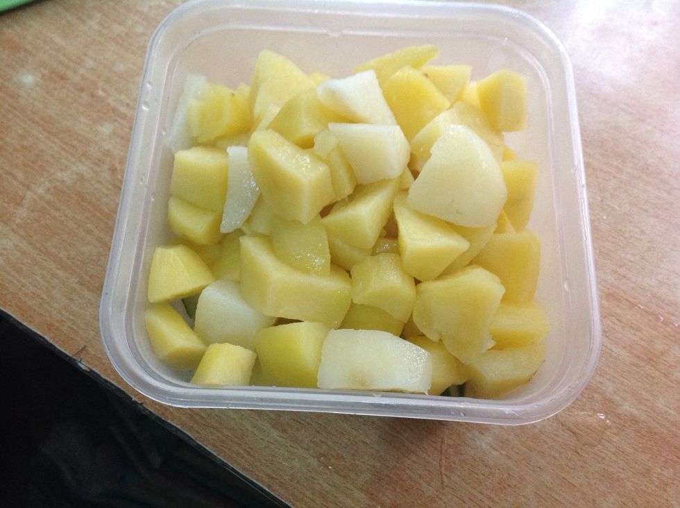 Transfer boiled potatoes into a bowl