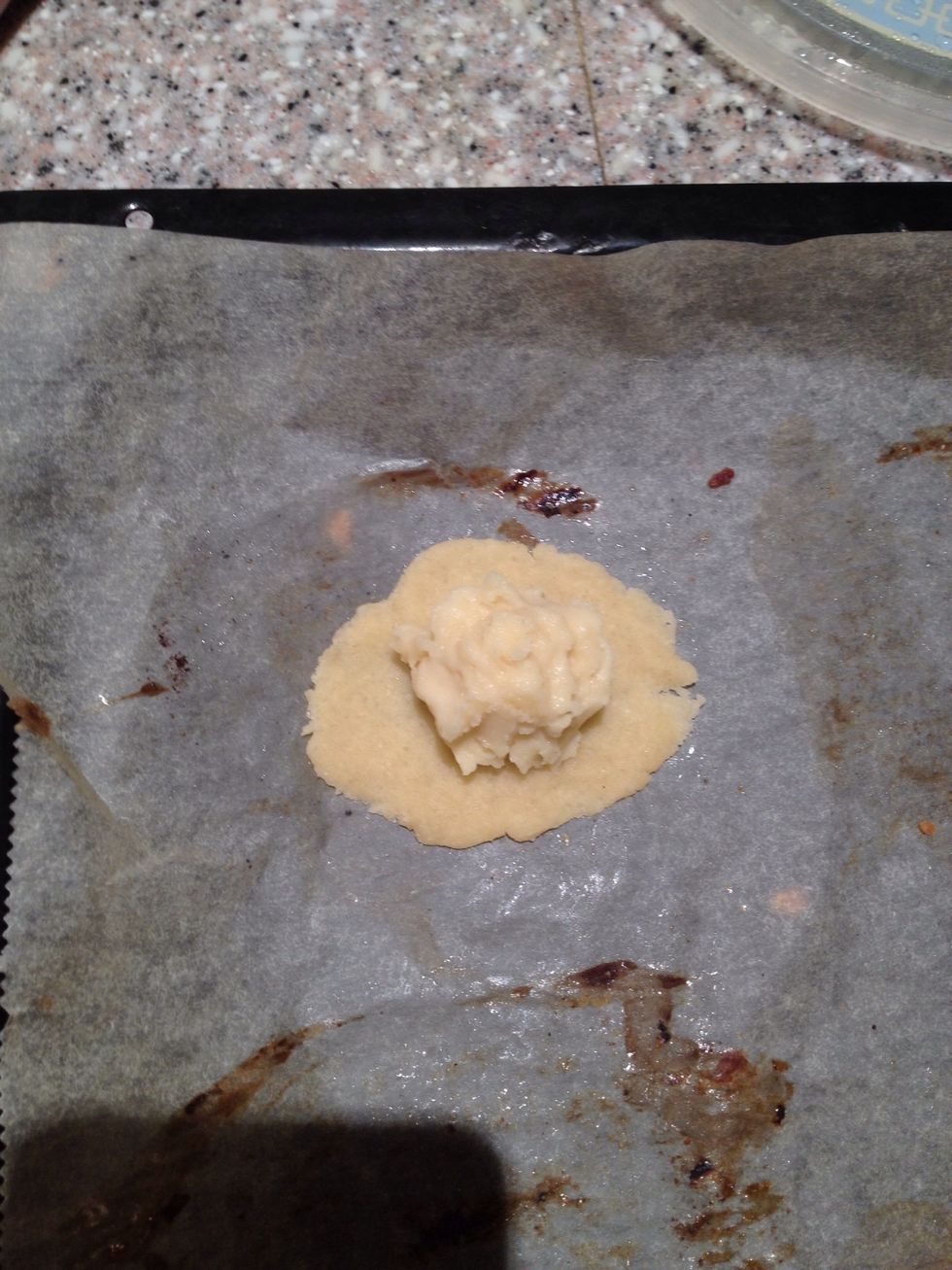 Transfer cookie to baking sheet, and place a teaspoon of egg custard at the middle of the cookie.