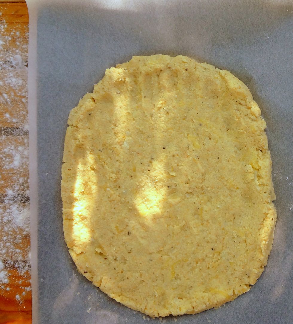 Transfer dough onto the prepared tray, flattening and shaping it with your hands, until the base is about 1.5 cm (1/2\u2019\u2019) thick. Make the edges slightly higher.