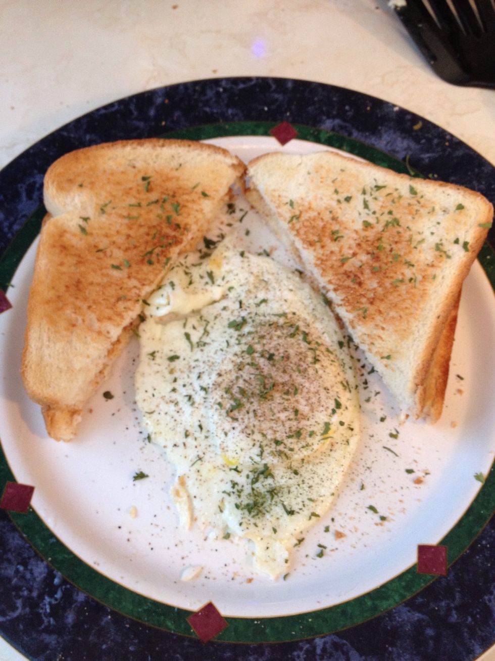 Transfer from pan to plate (flip it back to right-side-up on your plate) and garnish with a little salt, pepper and add some parsley flakes for presentation.