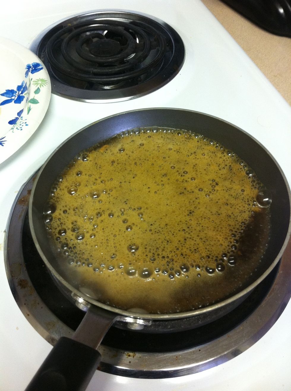 Transfer liquid to heated saut\u00e9 pan and bring to a boil. Reduce heat slightly and simmer until liquid is reduced by half. Remove from heat and stir in the butter.