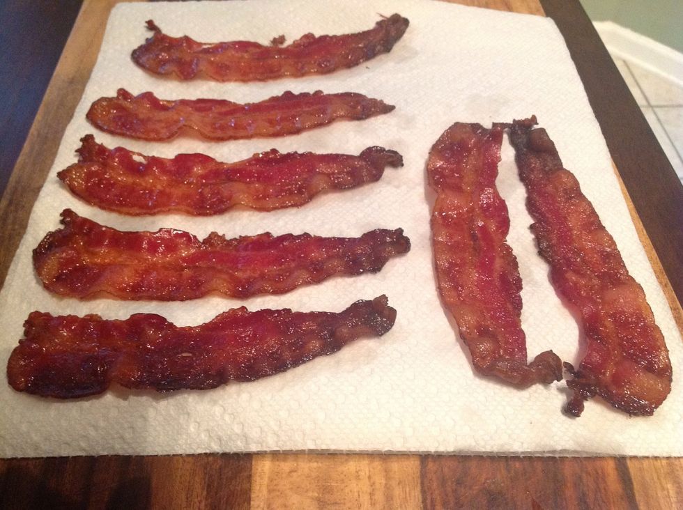 Transfer the bacon on to kitchen paper to absorb the excess fat and leave to cool.