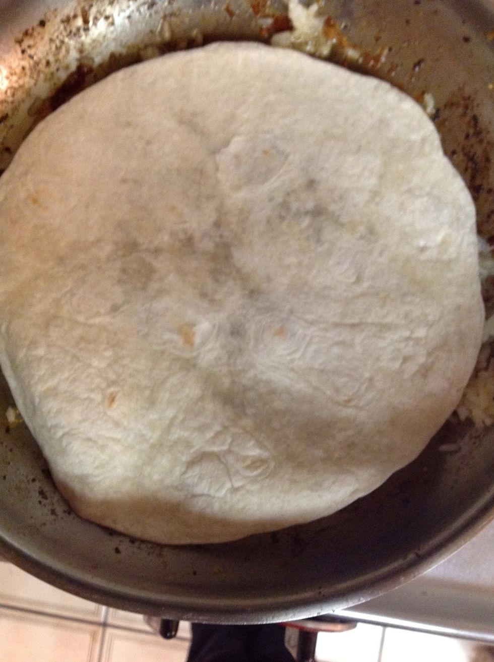 Transfer the chicken onto a plate so you can heat up your tortilla on the pan