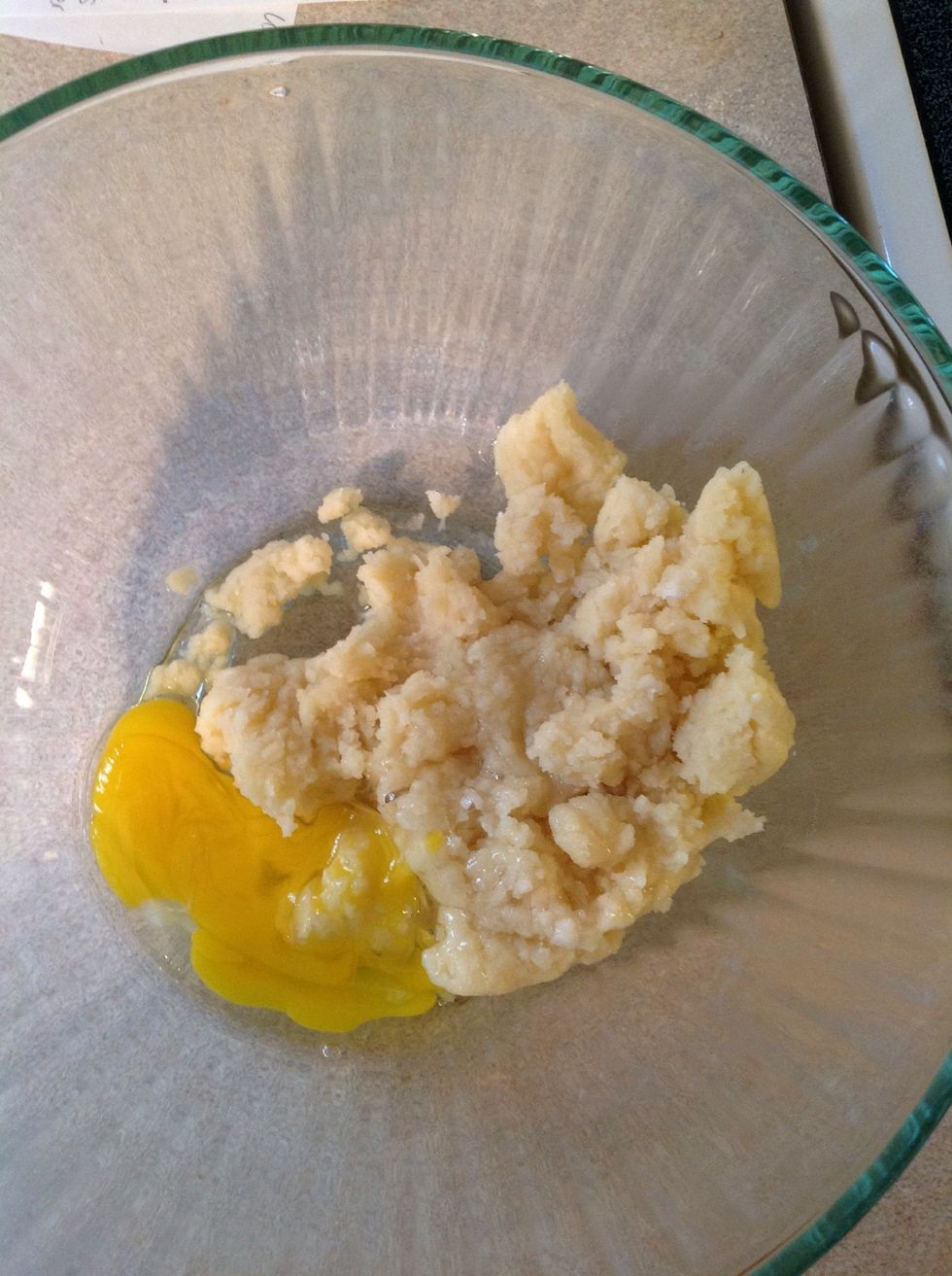 Transfer the dough to a mixing bowl. Using a wooden spoon or a stand mixer, beat in the eggs one at a time, mixing well after each. Mixing one egg at a time reduces the chances of your eggs curdling.