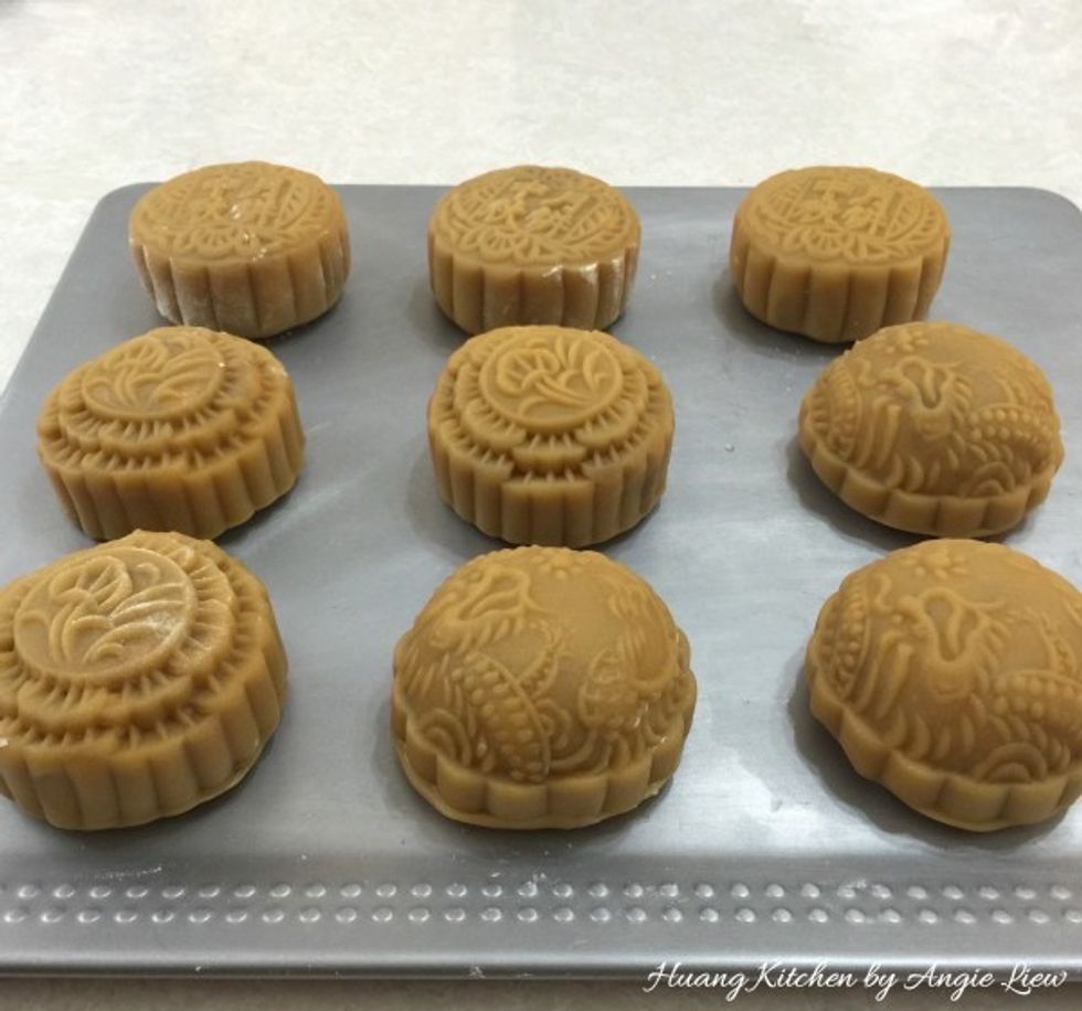 Transfer the moulded mooncakes onto a baking sheet.