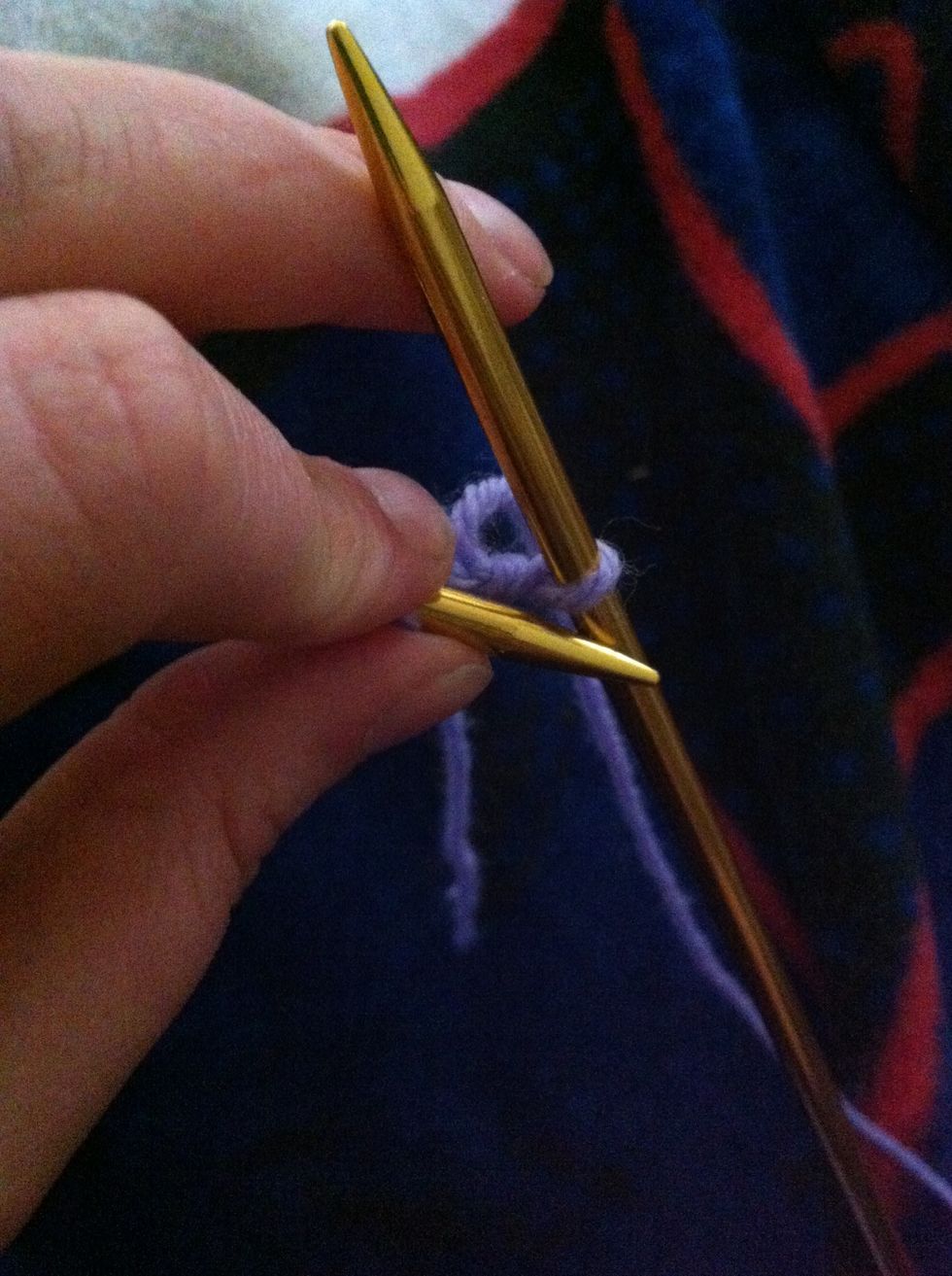 Transfer the new cast-on stitch from the right needle to the left needle by inserting the tip of the left needle into the loop of the stitch that you have just created on the right needle and slipping
